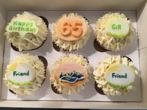 Vanilla birthday cupcakes with running shoe theme.
